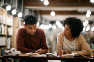 Female Tutor Working With Male Student Female Tutor Working With Male Student