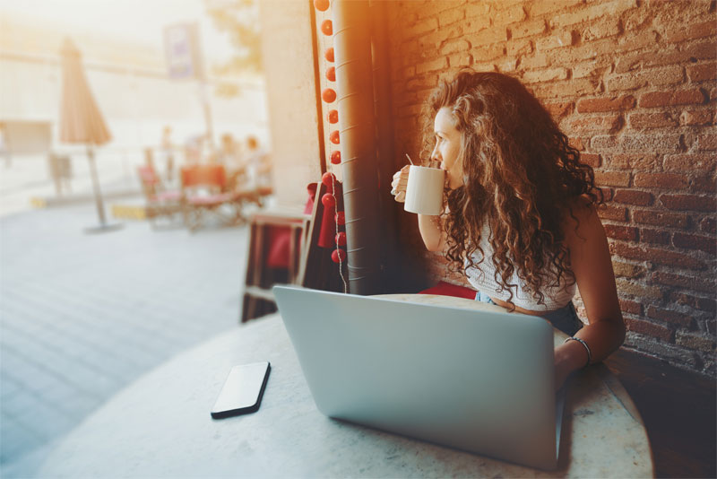 Woman Working Remote at Cafe Woman Working Remote at Cafe