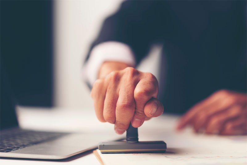 Man Stamping a Legal Document Man Stamping a Legal Document