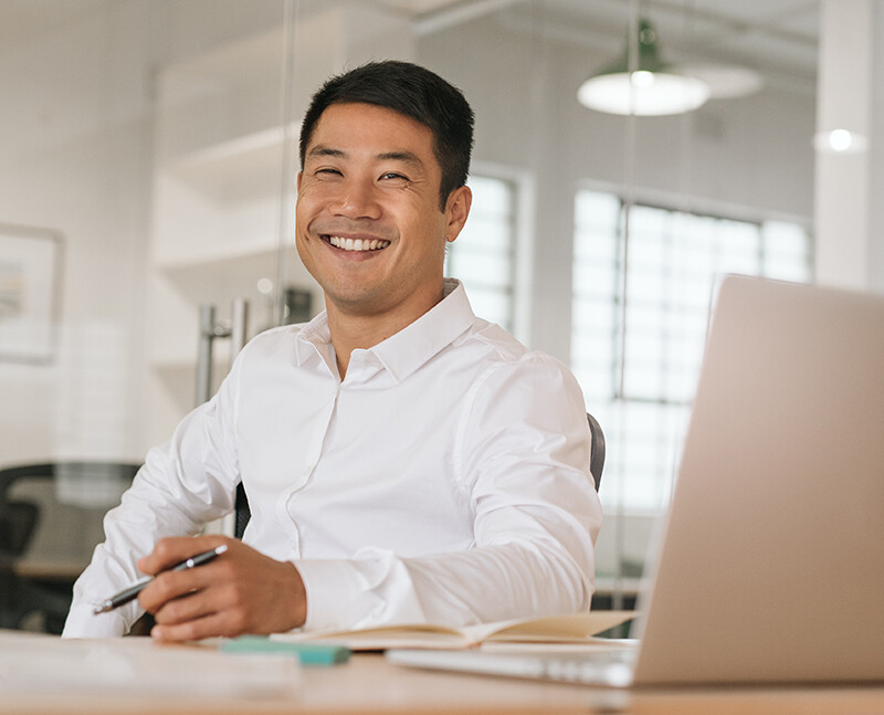 Man Smiling at Computer Man Smiling at Computer