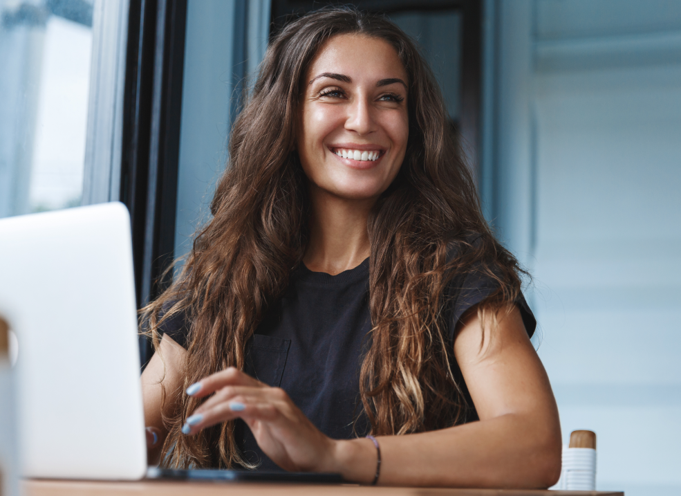 Smiling Woman Working on Her Computer Smiling Woman Working on Her Computer